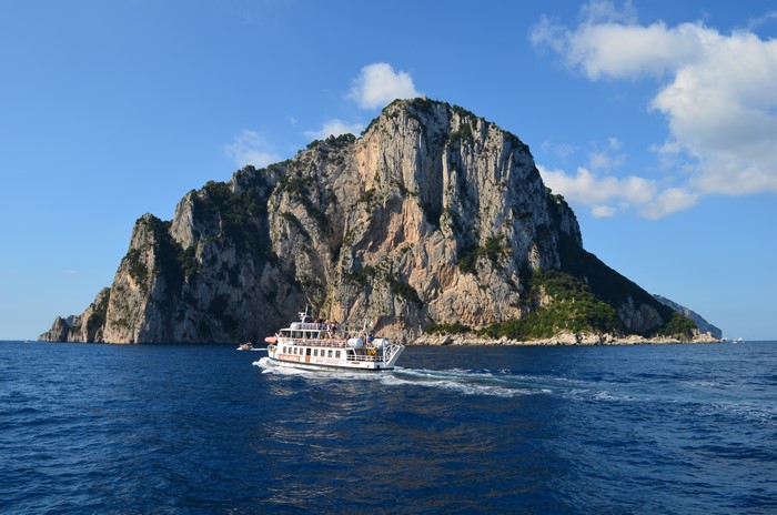 Boat near rocky island in the sea