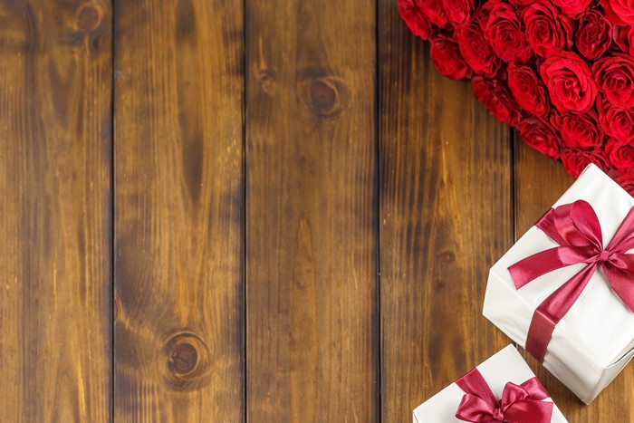 Red Roses and Gifts on Wood Planks