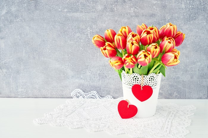 Tulips in a vase with red hearts