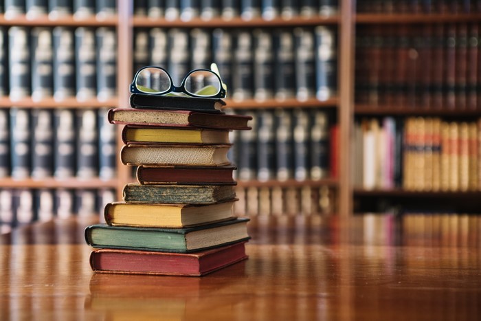 Stack of books with glasses in library