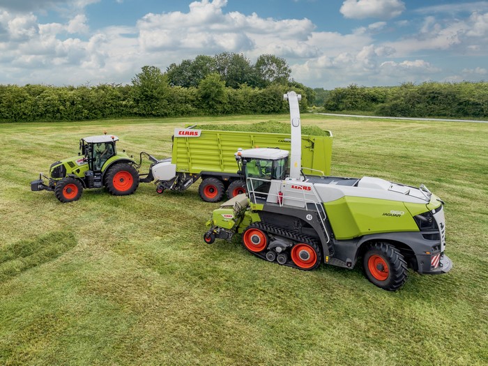 Claas Jaguar 960 Terra Trac and Tractor in a Field