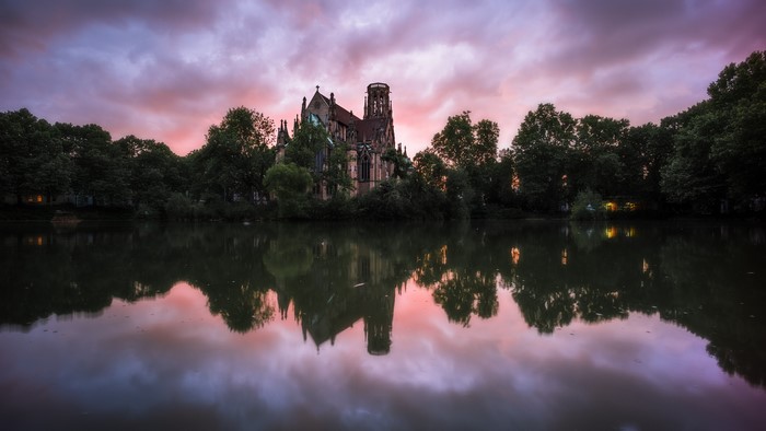 St. John's Church reflected in a lake at sunset