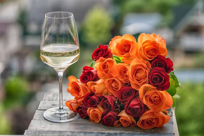 Roses bouquet and wine glass