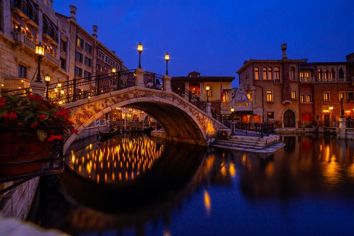 Bridge over canal with gondola at night in Tokyo Disneyland