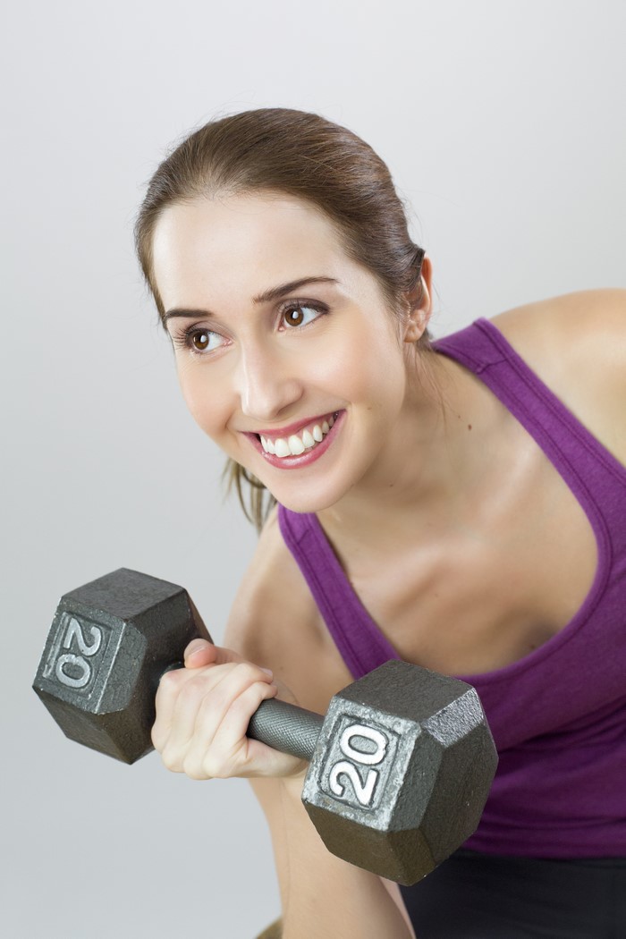 Woman lifting 20lb dumbbell