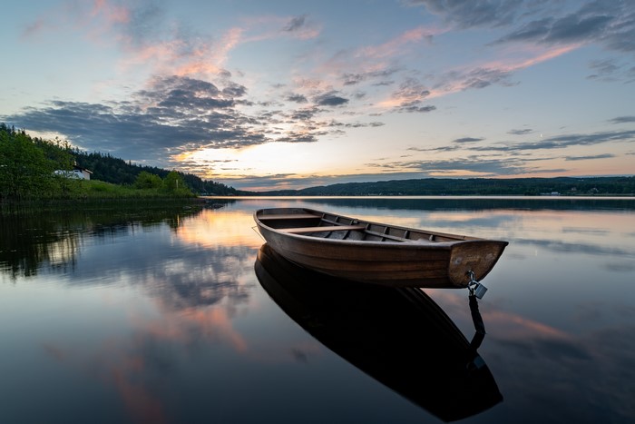 Wooden boat on a lake at sunrise