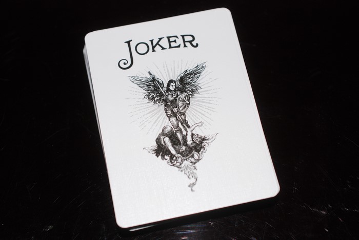 Joker playing card with angel and demon illustration