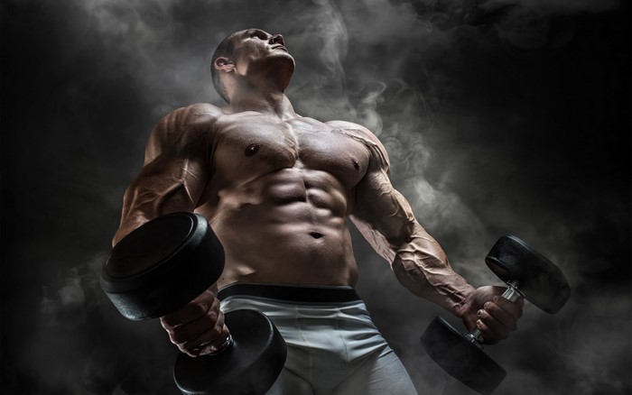 Muscular Man Lifting Dumbbells with Smoke