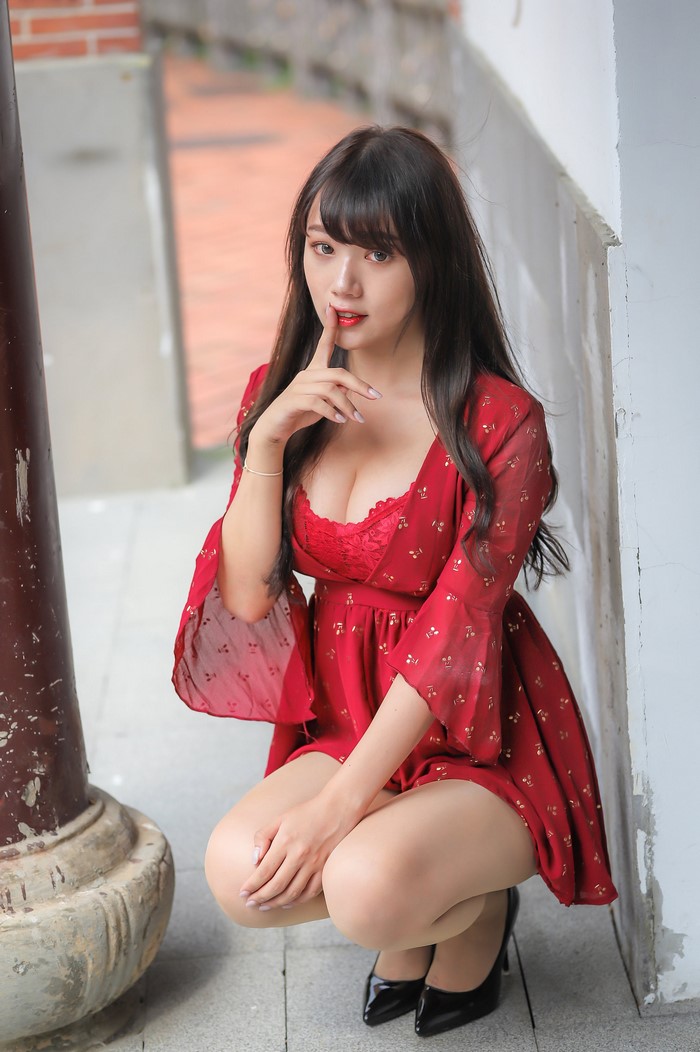 Asian Woman in Red Dress Sitting Pose