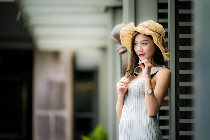 Asian woman wearing a straw hat and dress