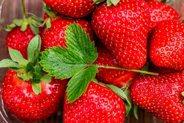 Close-up of fresh strawberries with green leaves