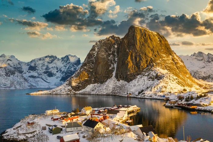 Snowy Lofoten village with mountains and bay