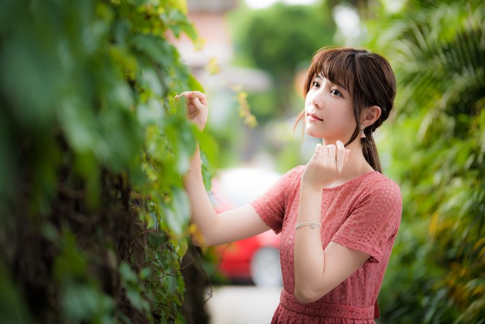 Asian woman with brown hair in a pink dress