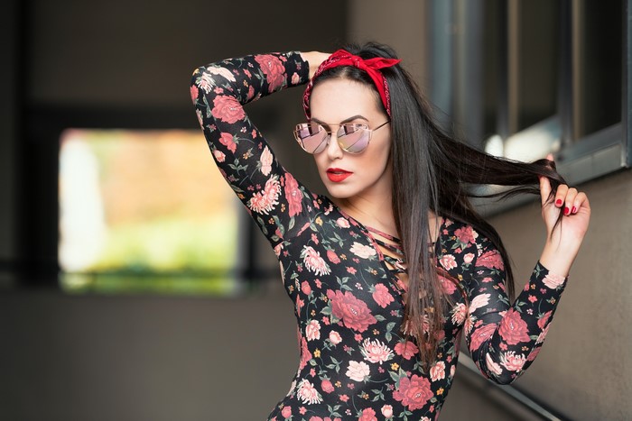 Brunette girl with heart-shaped glasses and red bandana