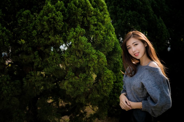 Asian woman with brown hair smiling