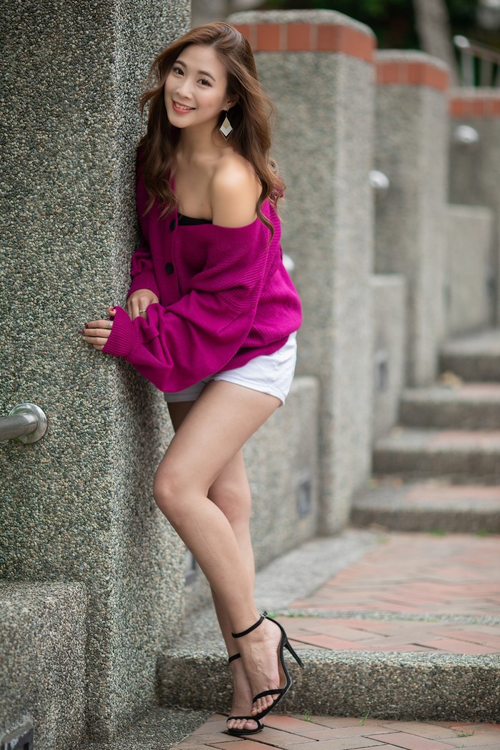 Asian Woman Smiling in Magenta Sweater and Shorts