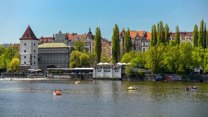 Prague riverfront with buildings and boats