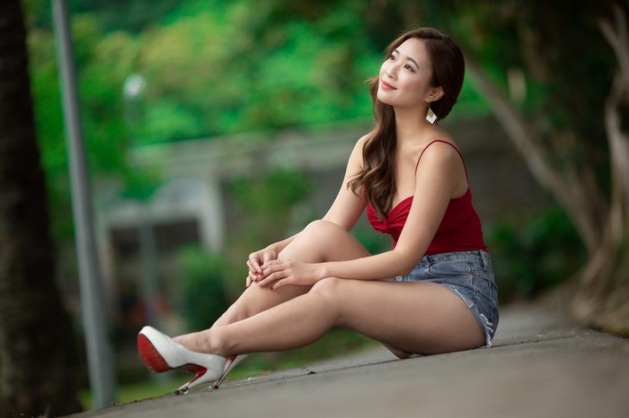 4K Asian Woman Sitting Wearing Shorts and Stilettos