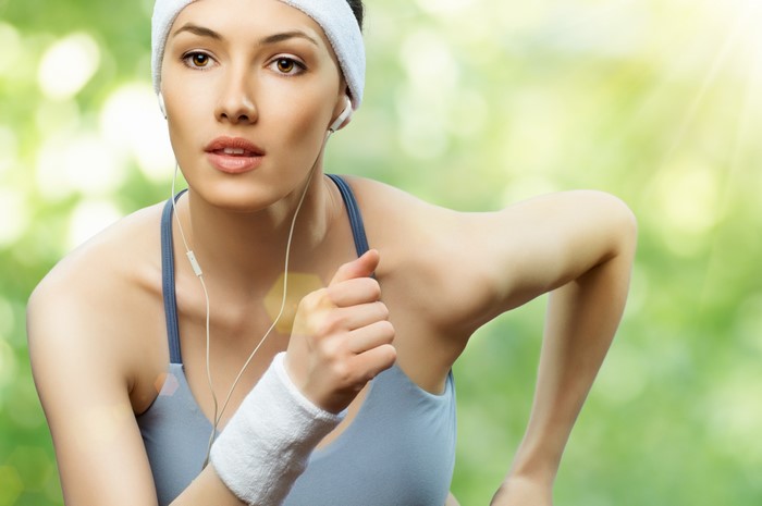Woman running with headphones and headband