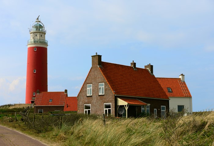 Red Lighthouse and Houses on Island Texel, Netherlands