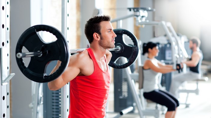 Man lifting barbell in gym