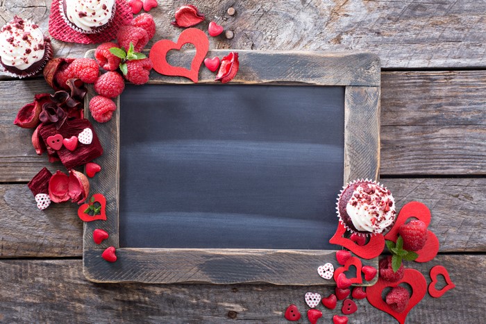 Valentine's Day chalkboard with raspberries and cupcakes