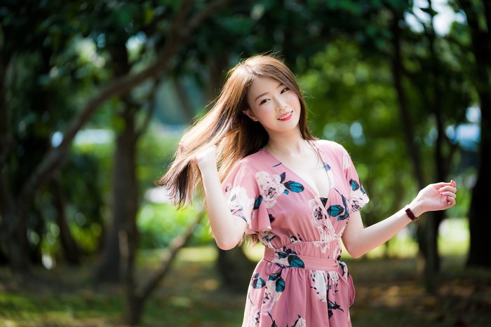 Asian woman with brown hair in a pink dress
