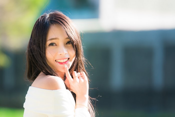 Asian woman with brown hair smiling