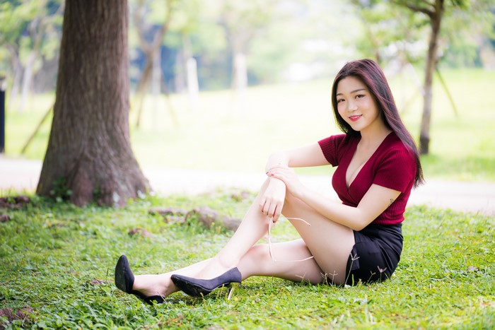 4K Asian Woman Sitting on Grass in Stilettos