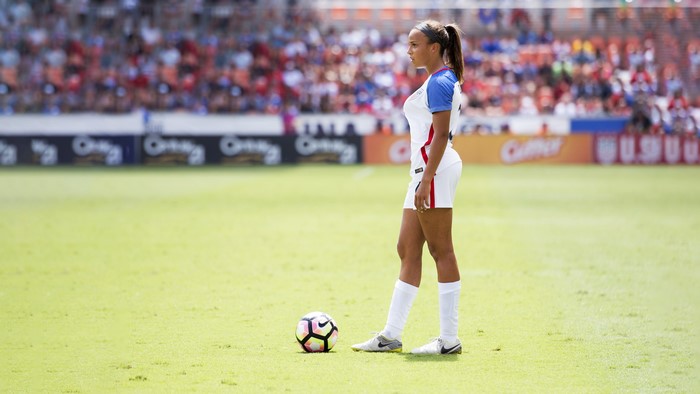 Soccer player with ball on field