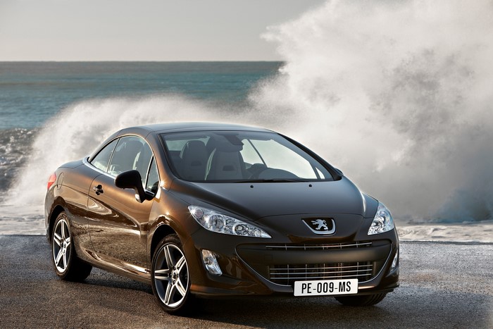 Metallic brown Peugeot 308 convertible by the ocean