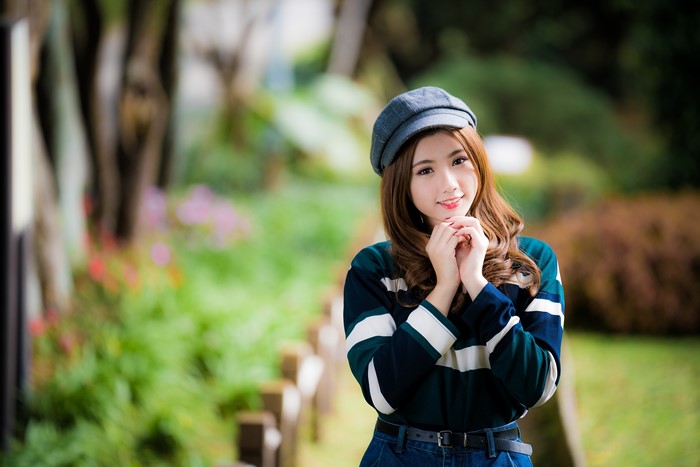 4K Asian Woman in Baseball Cap Smiling