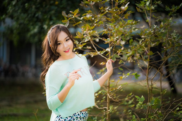 4K Portrait of Smiling Asian Woman with Branches