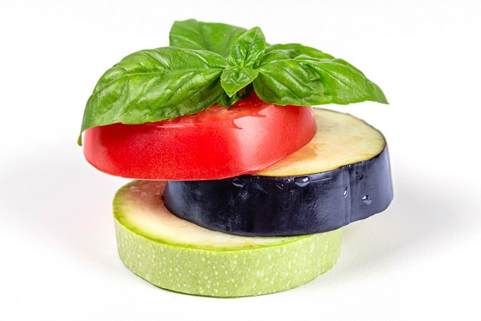 Stack of Tomato, Eggplant, Zucchini slices with Basil
