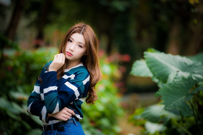 Asian woman with brown hair posing outdoors