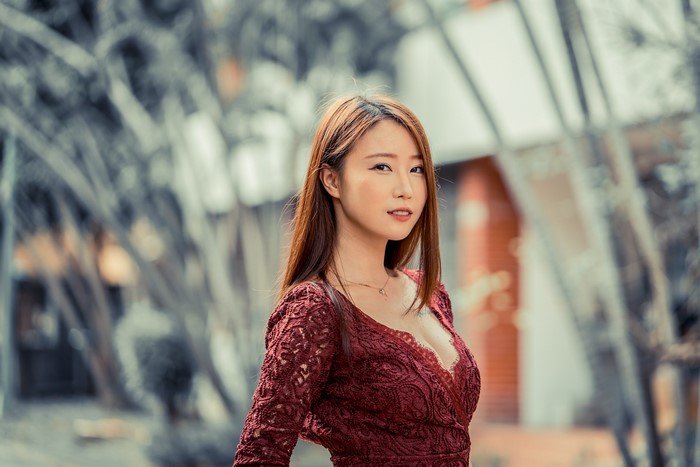 Asian woman with brown hair in a red dress