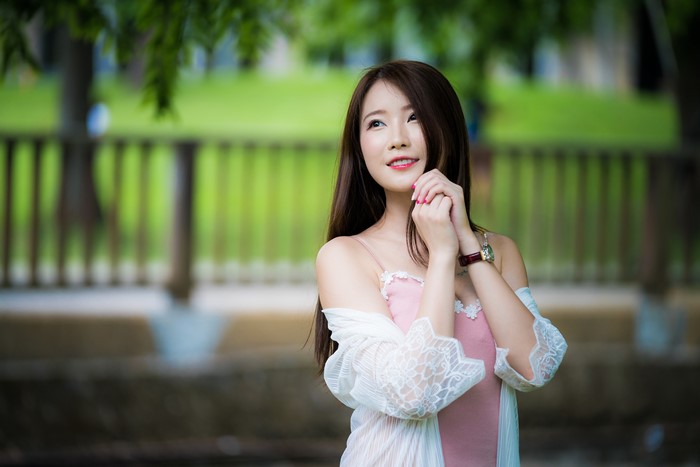 Asian woman with brown hair in pink dress