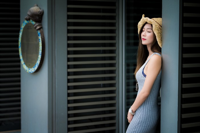 Asian woman with brown hair wearing a hat