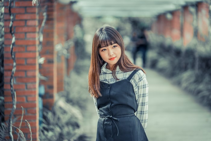 Asian girl with brown hair in a park