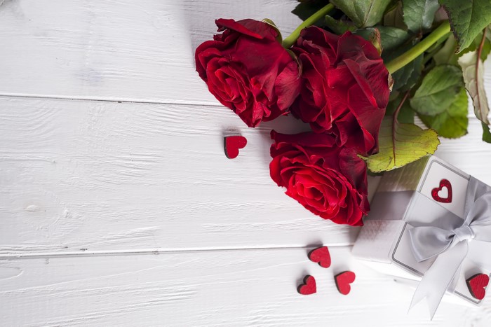 Red Roses and Gift Box with Hearts on Wood Planks