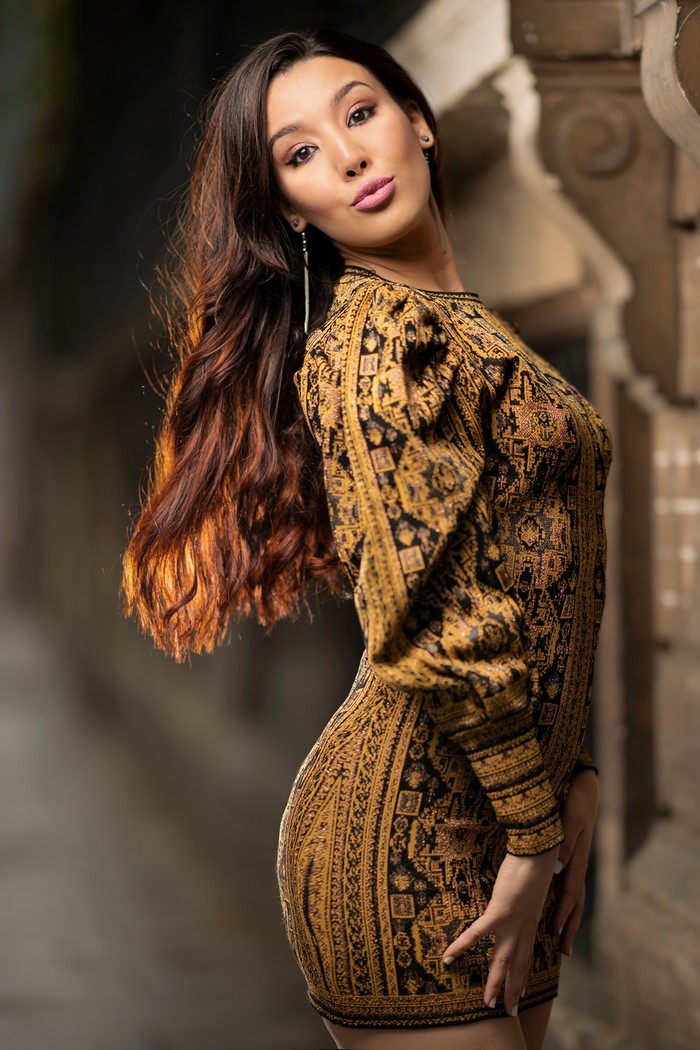 Woman with brown hair in a patterned dress