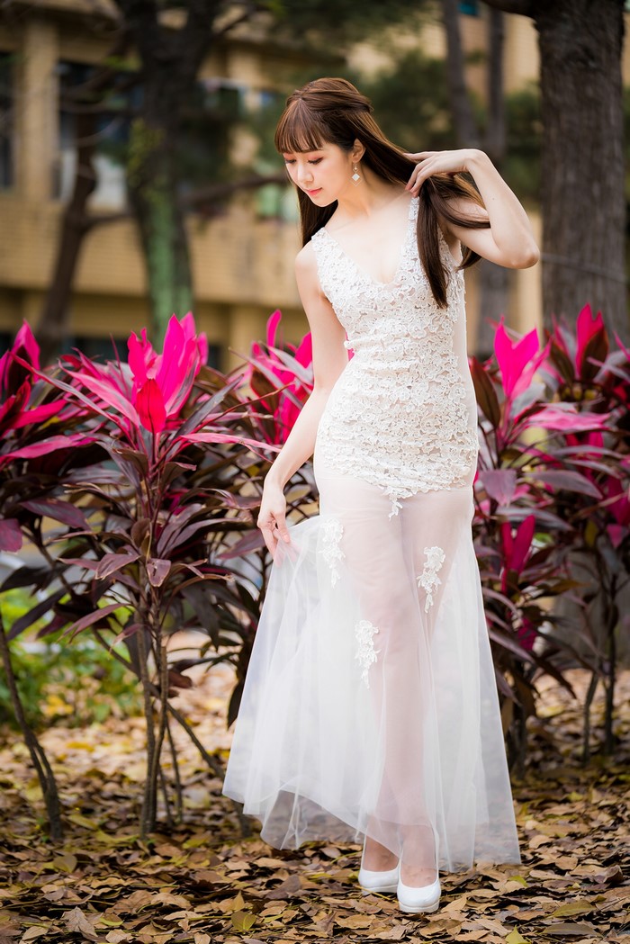Asian woman in a white lace dress
