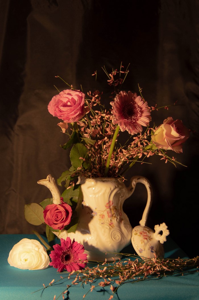 Still life with pink roses, gerberas, and a decorative vase