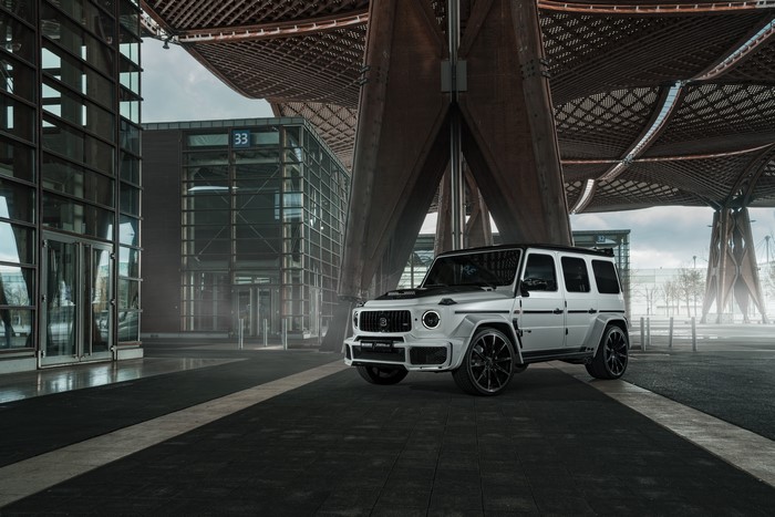 White Brabus 700 Widestar SUV parked near modern architecture