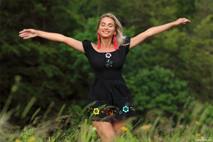 Blonde girl in a black dress with flowers