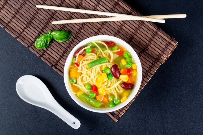 Vegetable soup with noodles and chopsticks