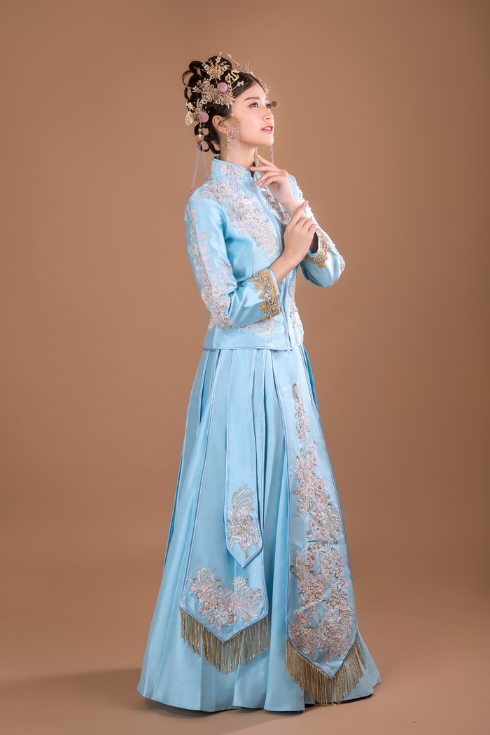 Woman in traditional blue dress and ornate headpiece
