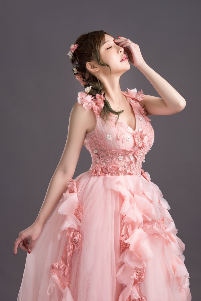 Woman in a pink dress with flowers in her hair
