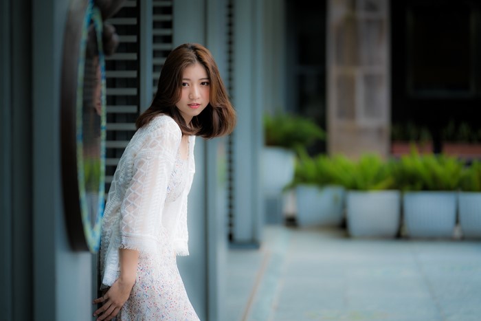 Asian woman with brown hair in white lace