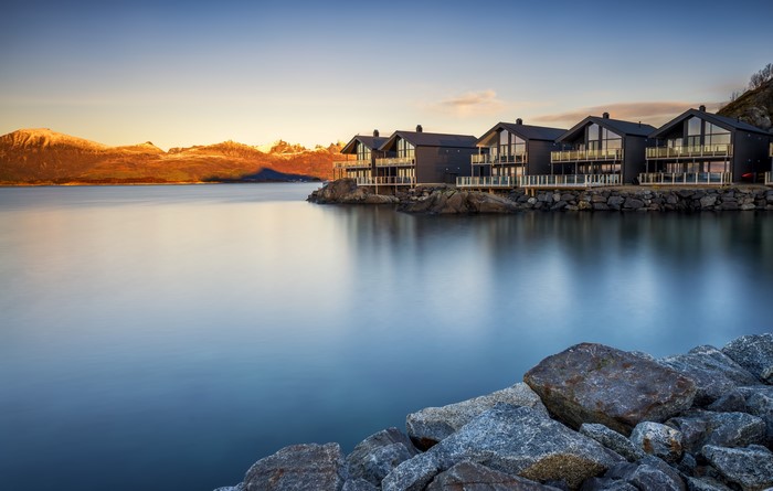 Modern houses on the coast of Norway at sunrise
